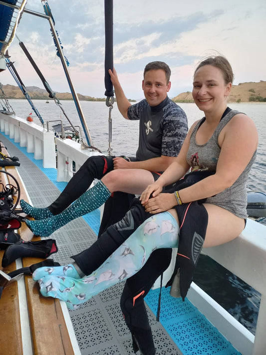 Two people sitting on a boat with a scenic background